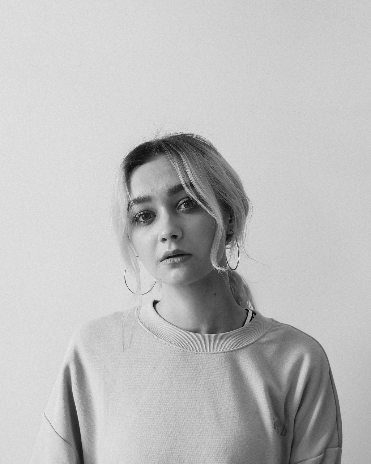 woman in a light crewneck sweatshirt