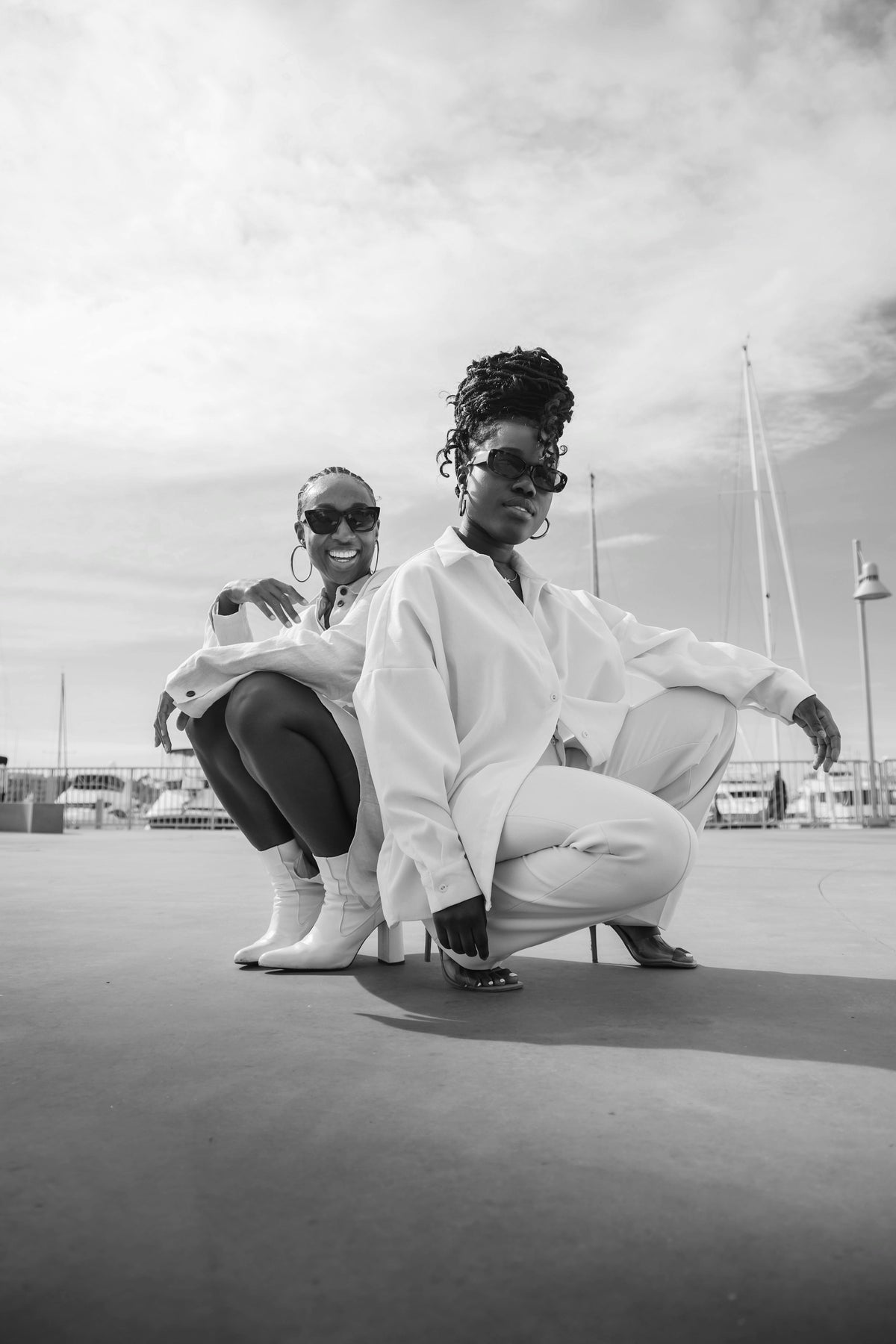 two women crouching in cream loungewear
