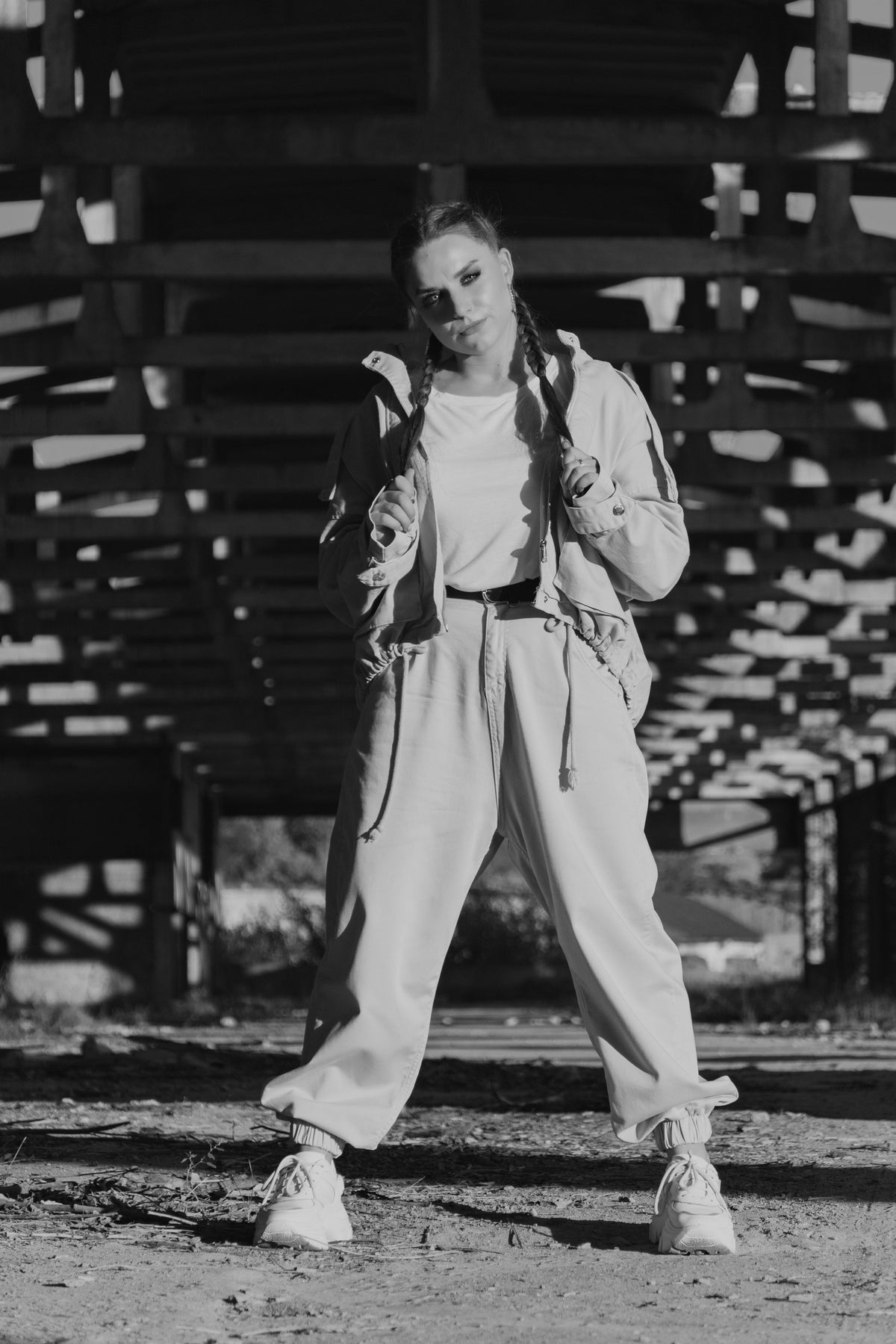 woman in a matching sweat set under a structure