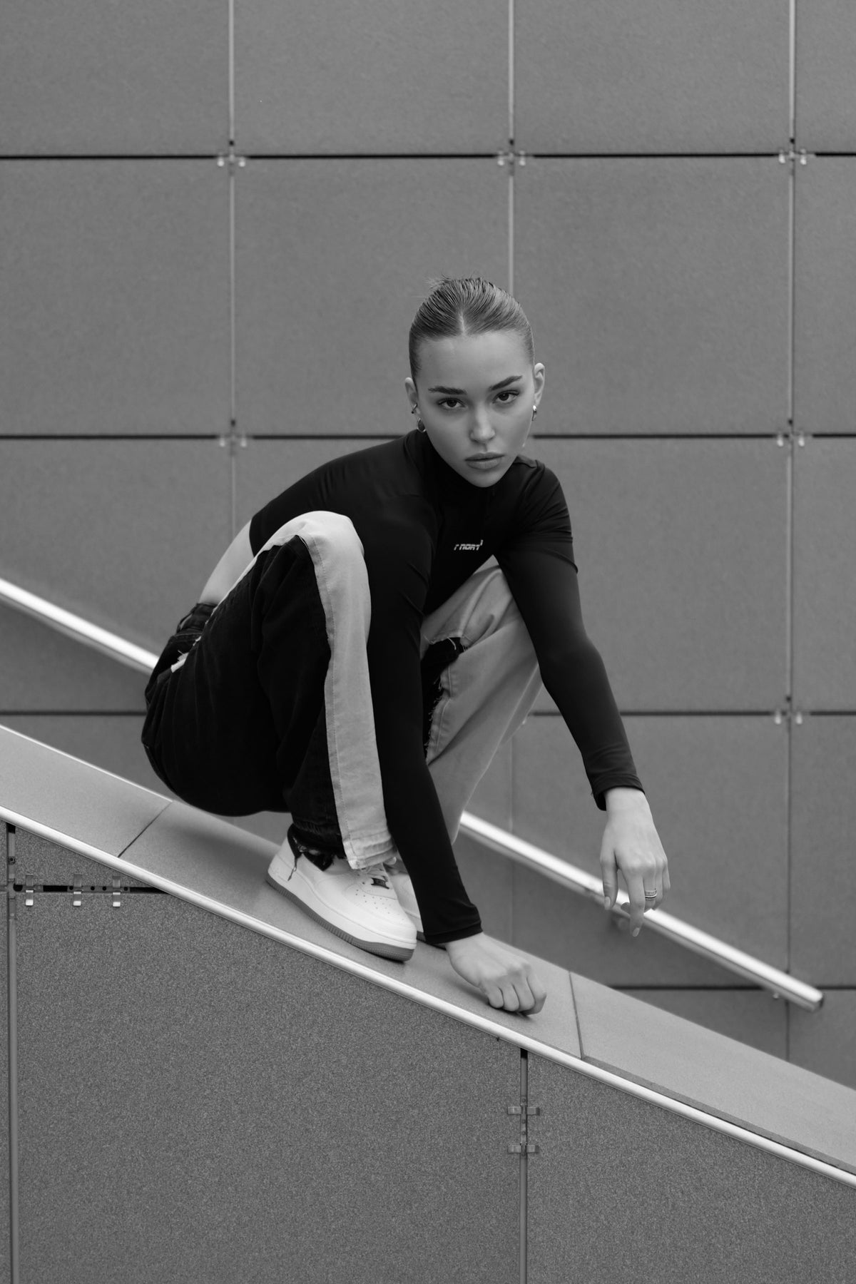woman in a black crewneck on a concrete ramp