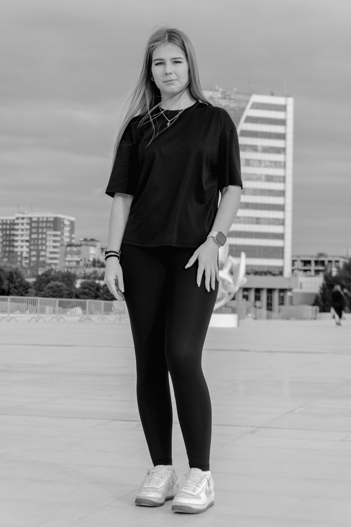 woman in a black tee and black leggings